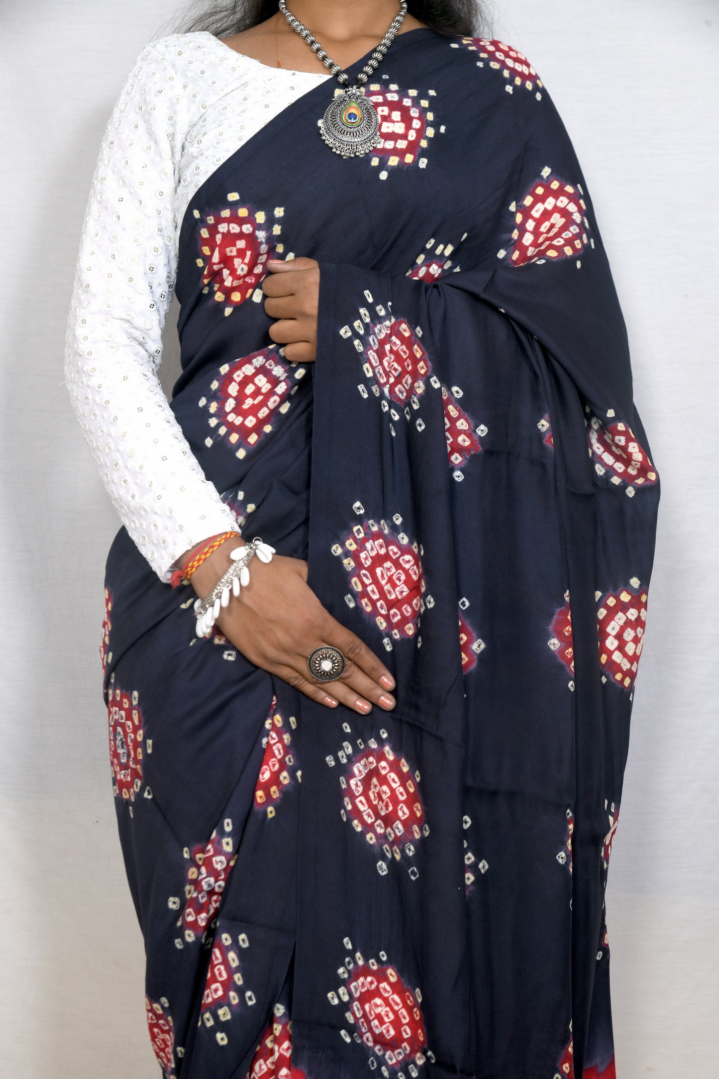 Elegant drape dark grey and red bandhani saree