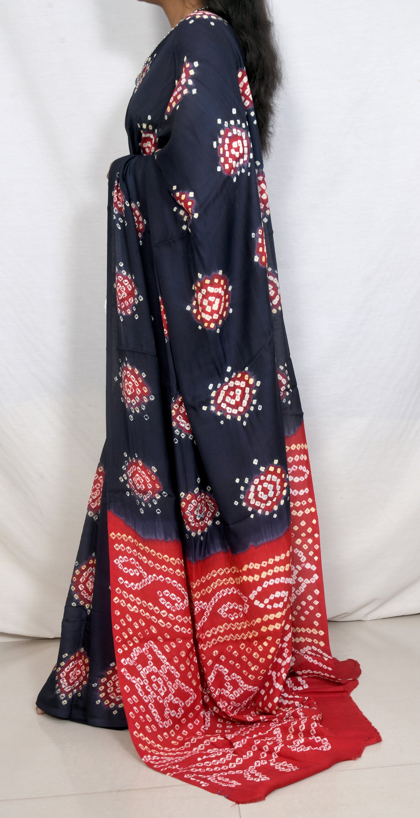Elegant drape dark grey and red bandhani saree