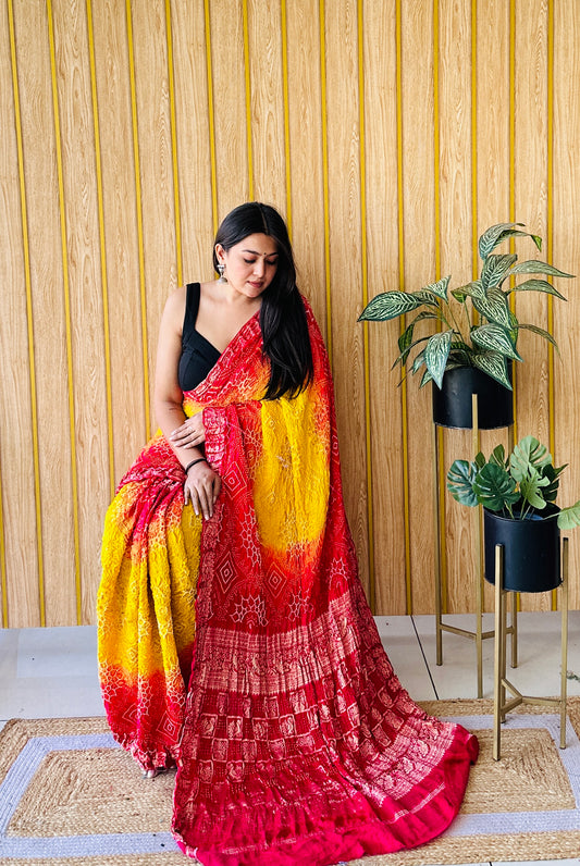 Graceful glimmer yellow and red bandhani saree