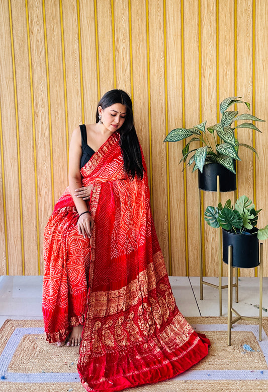 Tradition twirl red and orange bandhani saree
